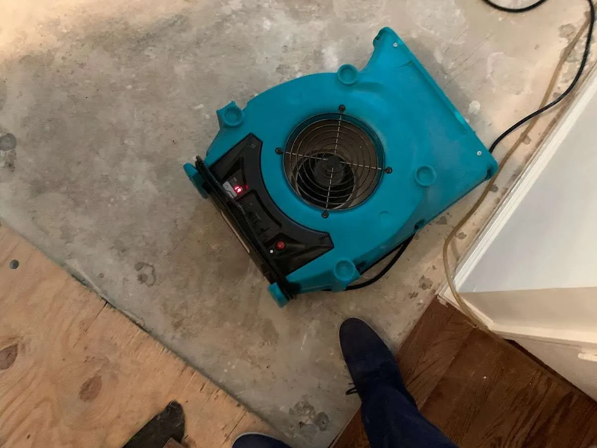 Air mover drying subfloor during Commercial Water Damage Restoration in Bessemer City